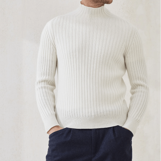 Brunello Cuccinelli cashmere sweater displayed in a high-end, modern setting, representing quiet luxury and premium men’s fashion.